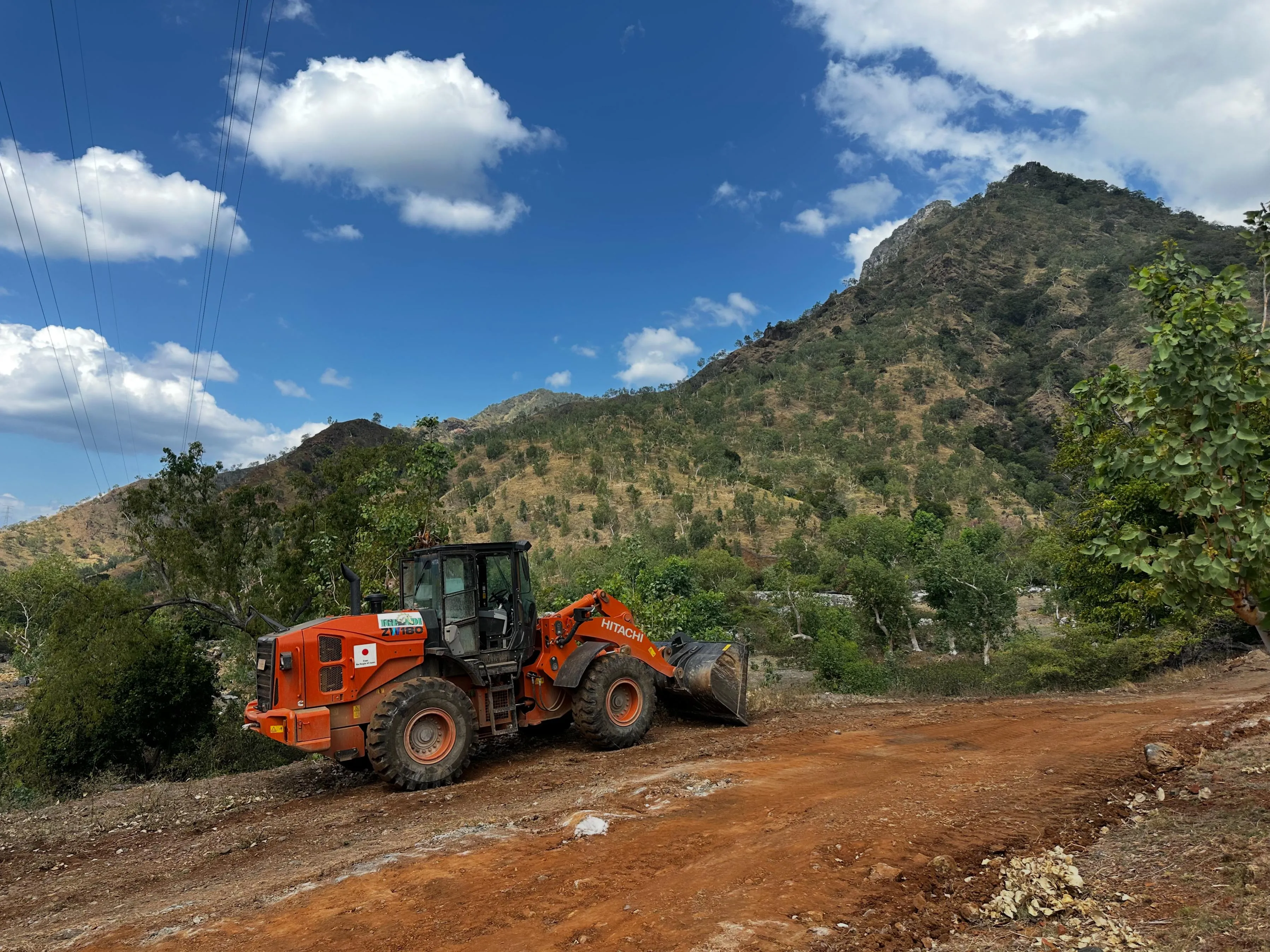 Wheel loader carrying out access-road earthworks for the Ilimanu White Marble Project