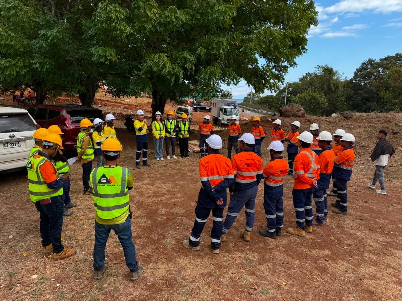 Project personnel gathered for an on-site briefing at the Ilimanu access-road works